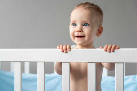 The child looks out of the crib with the hope that he will be taken away from thereの写真素材