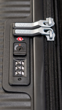 Novi Sad, Serbia - 29 January, 2023: Closeup of American tourister plastic suitcase with focus on the logo and combination lock password numberのeditorial素材