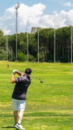 Belek, Turkey - May 13, 2022: Man playing golf in Sueno hotel golf Belek on driving range at golf course. Sueno golf club in Sueno resort in Belek, Turkeyのeditorial素材