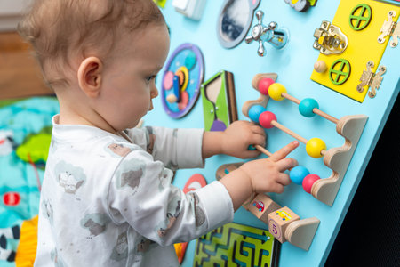 A child studies abacus on a busy boardの写真素材