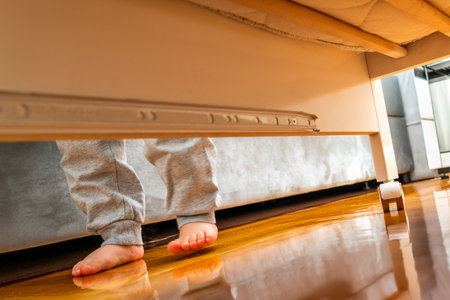The babys little feet are walking on the floor. Covert Surveillance Effectの写真素材