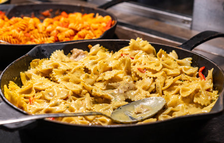 Delicious cooked Italian farfalle pasta butterfly or bow with cheese sauce.の写真素材