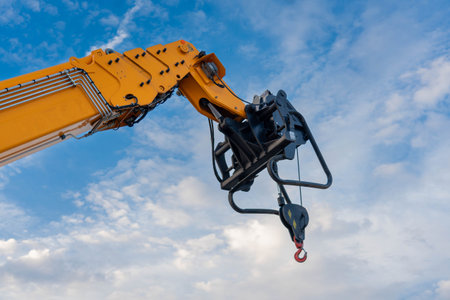 A lifting mechanism with a hook at the end of the boom of a heavy truck craneの写真素材