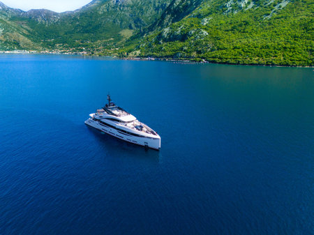 Luxury yacht in the bay at anchor. The recipe for a luxurious successful lifeの写真素材