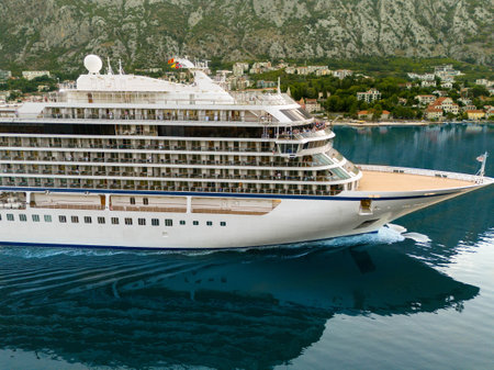 Cruise ship sailing in the bay to the berth, side view of the decks and bowの写真素材