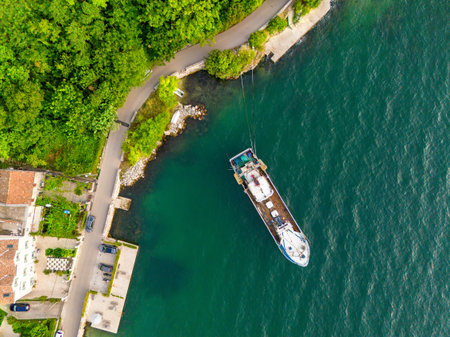An old fishing boat parked near the embankment of a small villageの写真素材