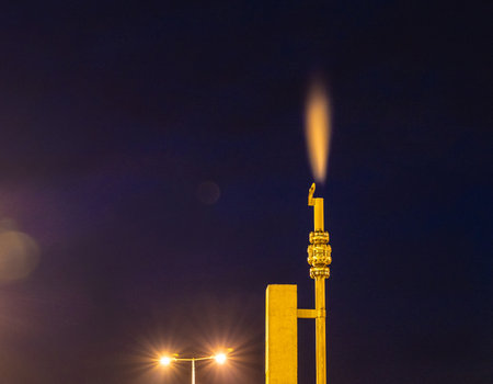 Gas venting during pipeline maintenance captured at night with a flare.の写真素材