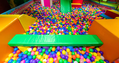 A vibrant ball pit filled with colorful balls and soft play elements for kids fun.の写真素材