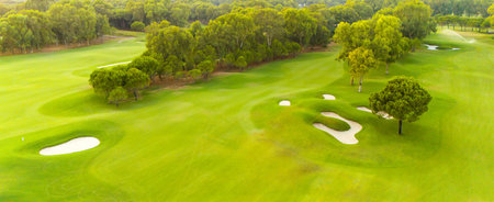 An aerial view of a golf course with sand traps and lush greeneryの写真素材
