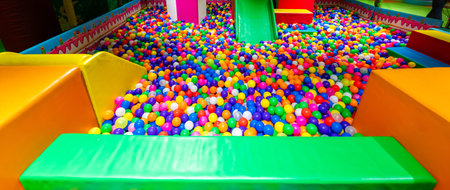 Spacious ball pit with colorful spheres and soft play structures for kids active fun.の写真素材