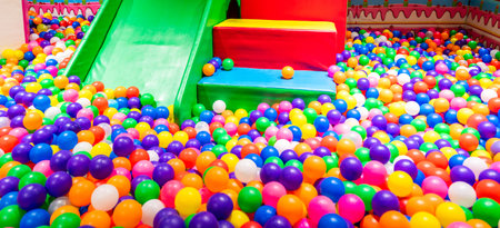 Indoor playground with a colorful ball pool and slide for childrenの写真素材