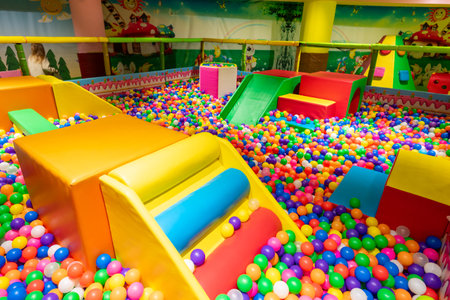 Bright and engaging indoor playground with colorful ball pit and vibrant play structures.の写真素材