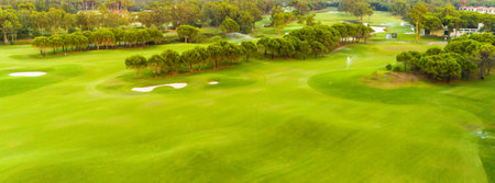 An aerial view of a spacious golf course with sand traps and open greenery.の写真素材