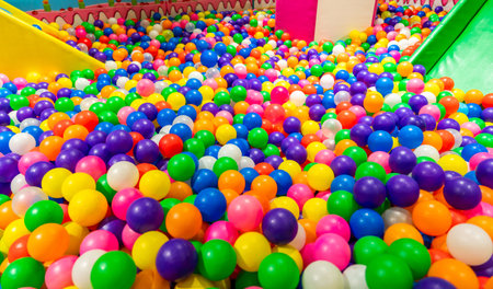 Colorful ball pit and green slide inviting kids for endless funの写真素材