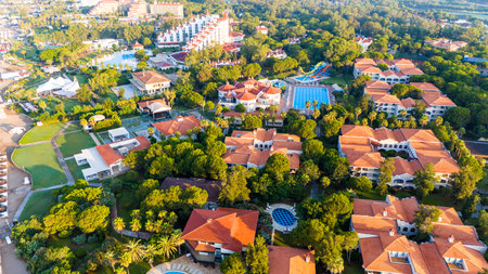 Aerial view of a luxury resort with private villas, lush gardens, and scenic poolsの写真素材