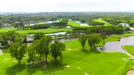 Aerial view of a golf course with water hazards and lush green fairwaysの写真素材