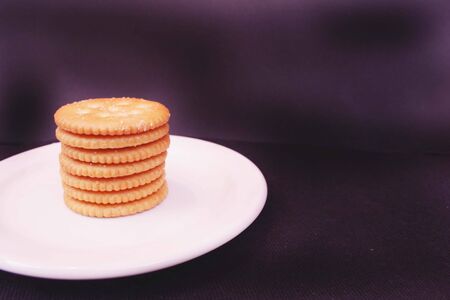 Stack of yellow crackers on plateの写真素材