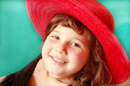 Pretty little girl in a bright red hatの写真素材