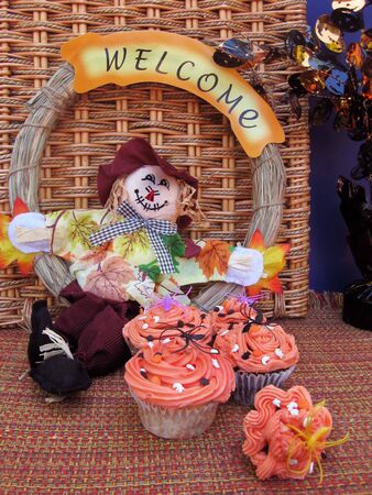 Cupcakes decorated in orange for Halloween with scarecrow の写真素材