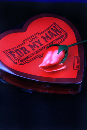 Valentine box of chocolates with red rose on top