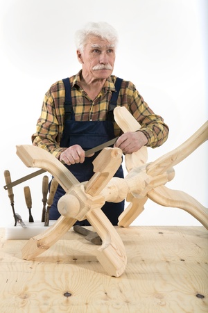 Old woodcarver work in the workshopの写真素材