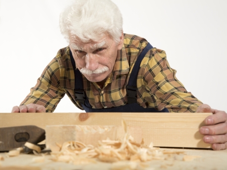 Old woodcarver work in the workshopの写真素材