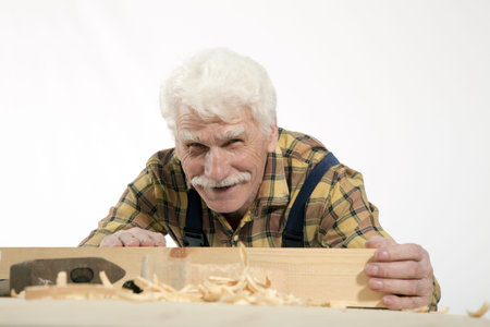 Old woodcarver work in the workshop