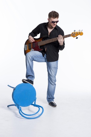 Bass player with attitude playing guitar gently in love with musicの写真素材