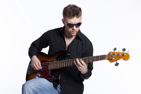 Bass player with attitude playing guitar gently in love with musicの写真素材