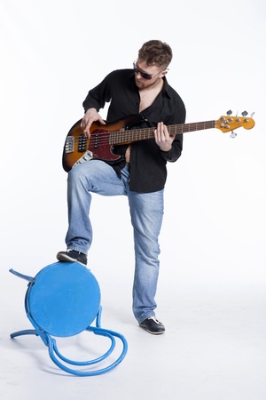 Bass player with attitude playing guitar gently in love with musicの写真素材