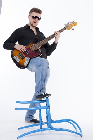 Bass player with attitude playing guitar gently in love with musicの写真素材