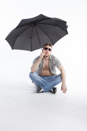 young athletic businessman under umbrellaの写真素材