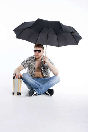 young athletic businessman under umbrellaの写真素材