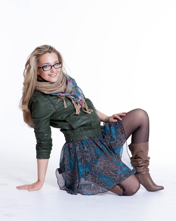 Beautiful blonde girl with a photo camera with glasses photographer rehearses photoshootの写真素材