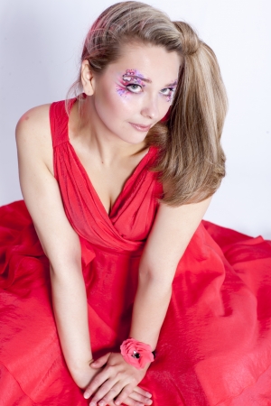 Beautiful young smiling woman in a red dressの写真素材
