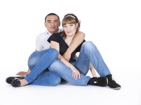 Portrait of a romantic young couple sitting together on a white background, they have a wedding tomorrowの素材 [FY31019670984]