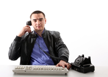 Young businessman isolated on white, old phoneの写真素材