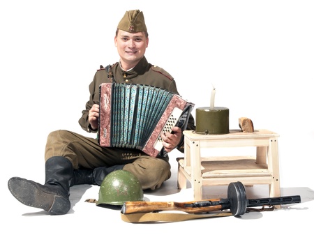 The soldier with the accordion near military tacklesの写真素材