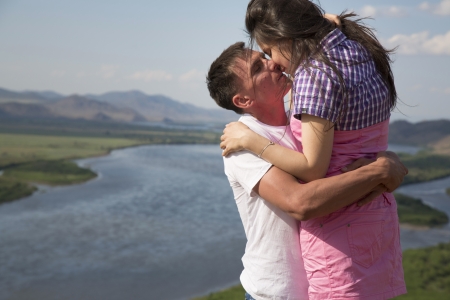 happy Young Couple kissing in mountainsの写真素材