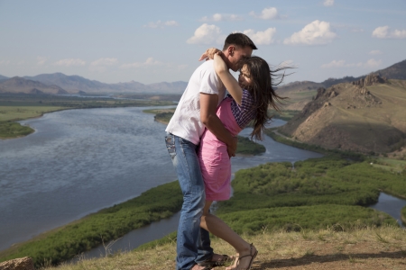 happy Young Couple kissing in mountainsの写真素材