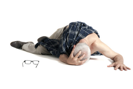 Upset man covered with blanket lying on on the floor on white background