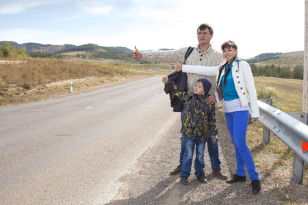  young family catches the car on the trackの写真素材