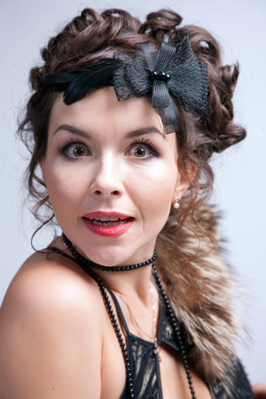 emotional woman posing in studio, wearing clothes in retro style