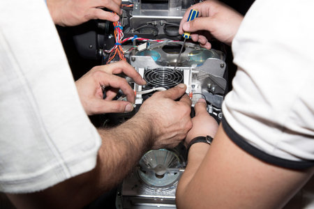 men doing repair of technique  close up