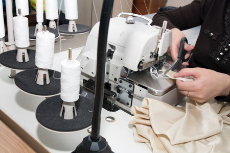  woman sews clothes on sewing machine