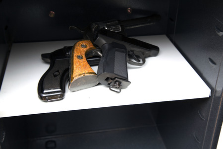 three pistols in the open safeの写真素材