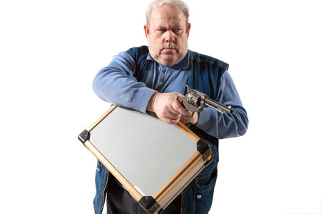 mature man with gun and case isolated on whiteの写真素材