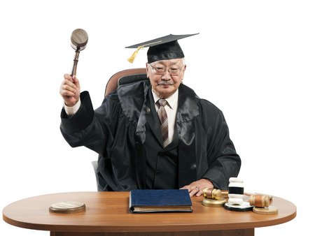 mature man judge at table isolated on white の写真素材
