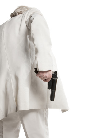 businessman in a white suit holding a gunの写真素材