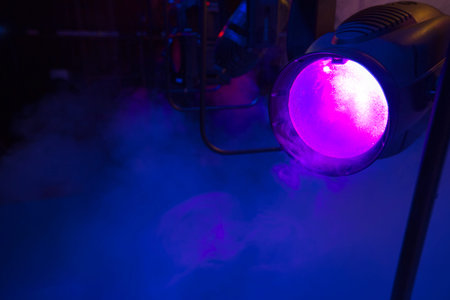 stage colored lights on a console, smoke